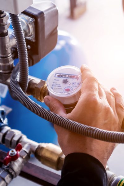 Technician checking water system nodes. Technician checking water system nodes. Industrial background